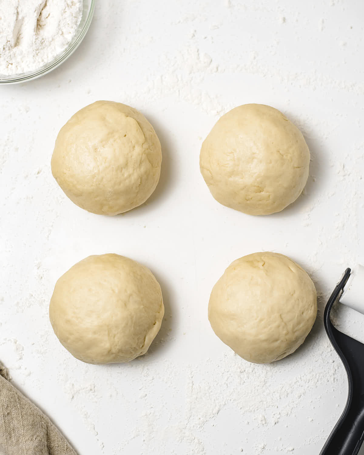 Dough separated into 4 smaller dough balls.