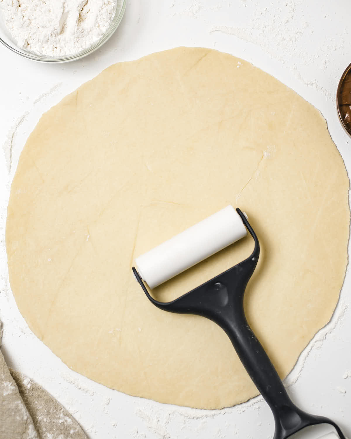 Rolling the dough balls into circles.