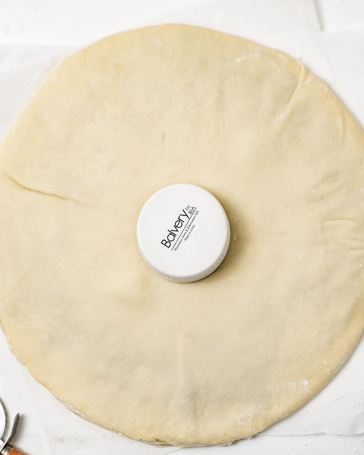 Using a cup to create the round center.