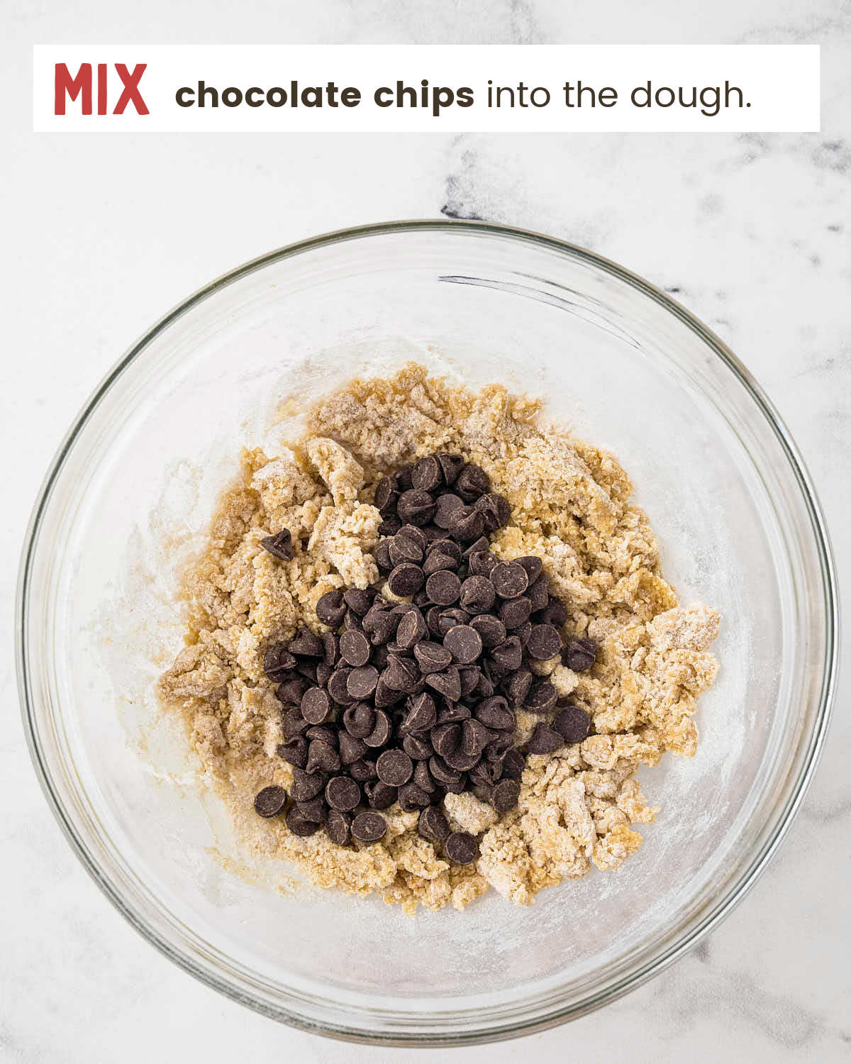 Stirring chocolate chips into the dough.