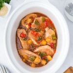 Sweet and Sour Pork Chops in a white slow cooker.