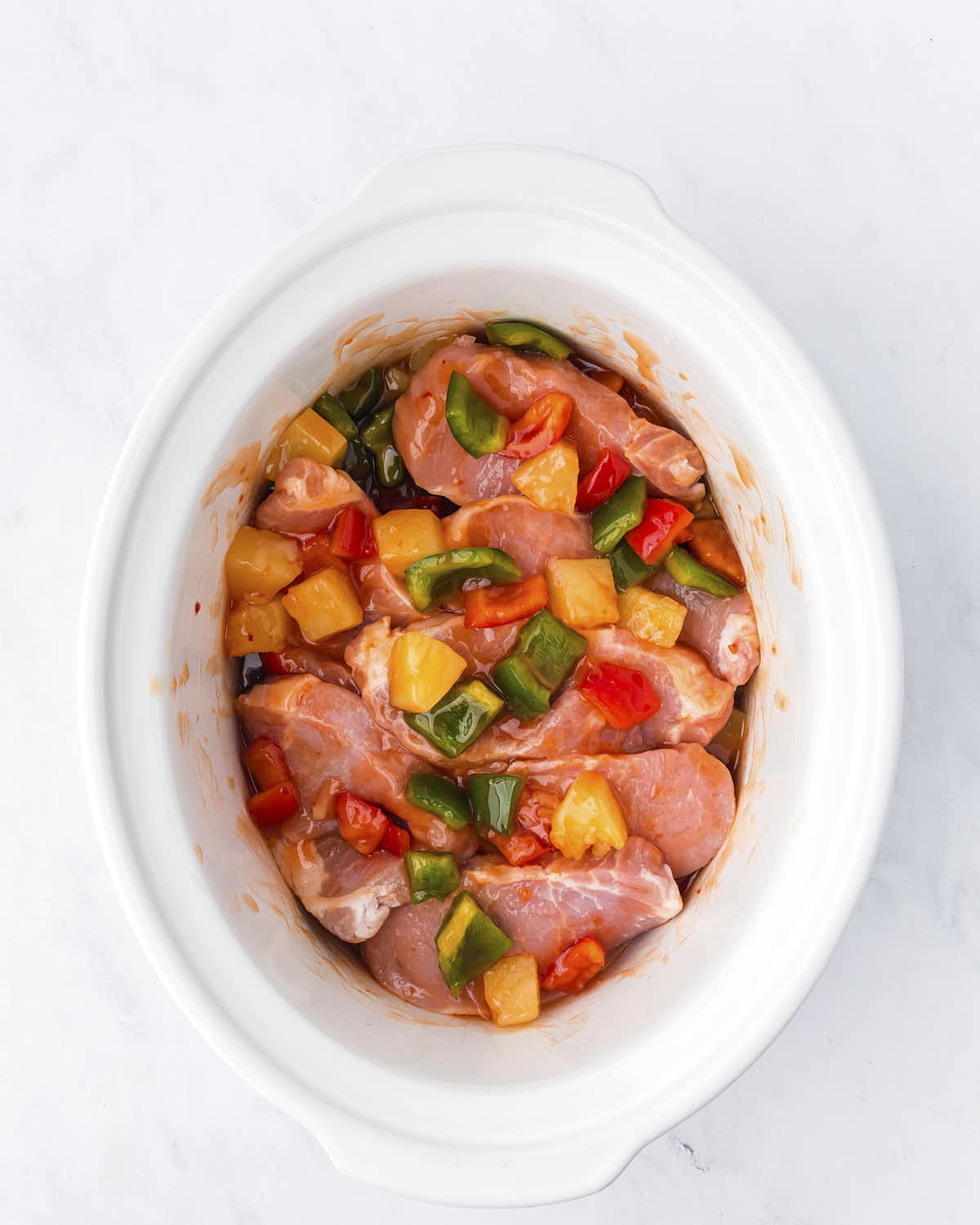 Pork Chops added to the slow cooker.