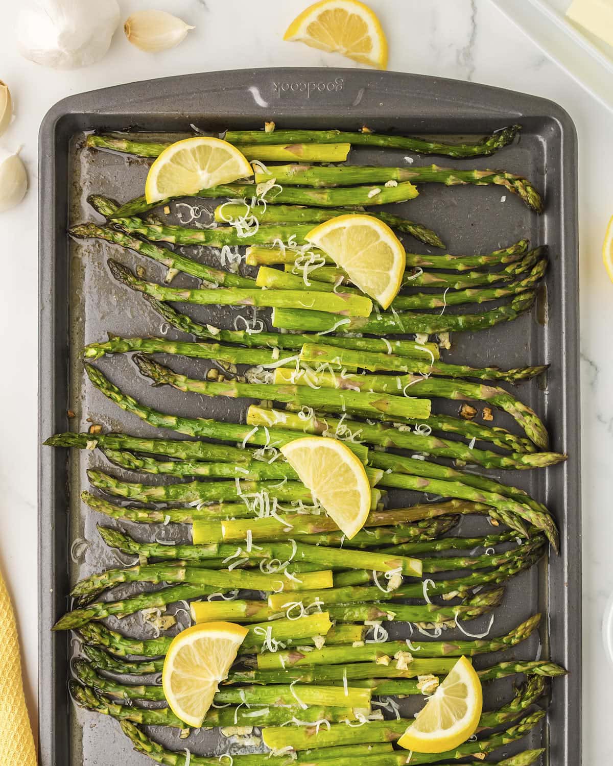 Oven Roasted Asparagus topped with lemon slices and grated parmesan. 