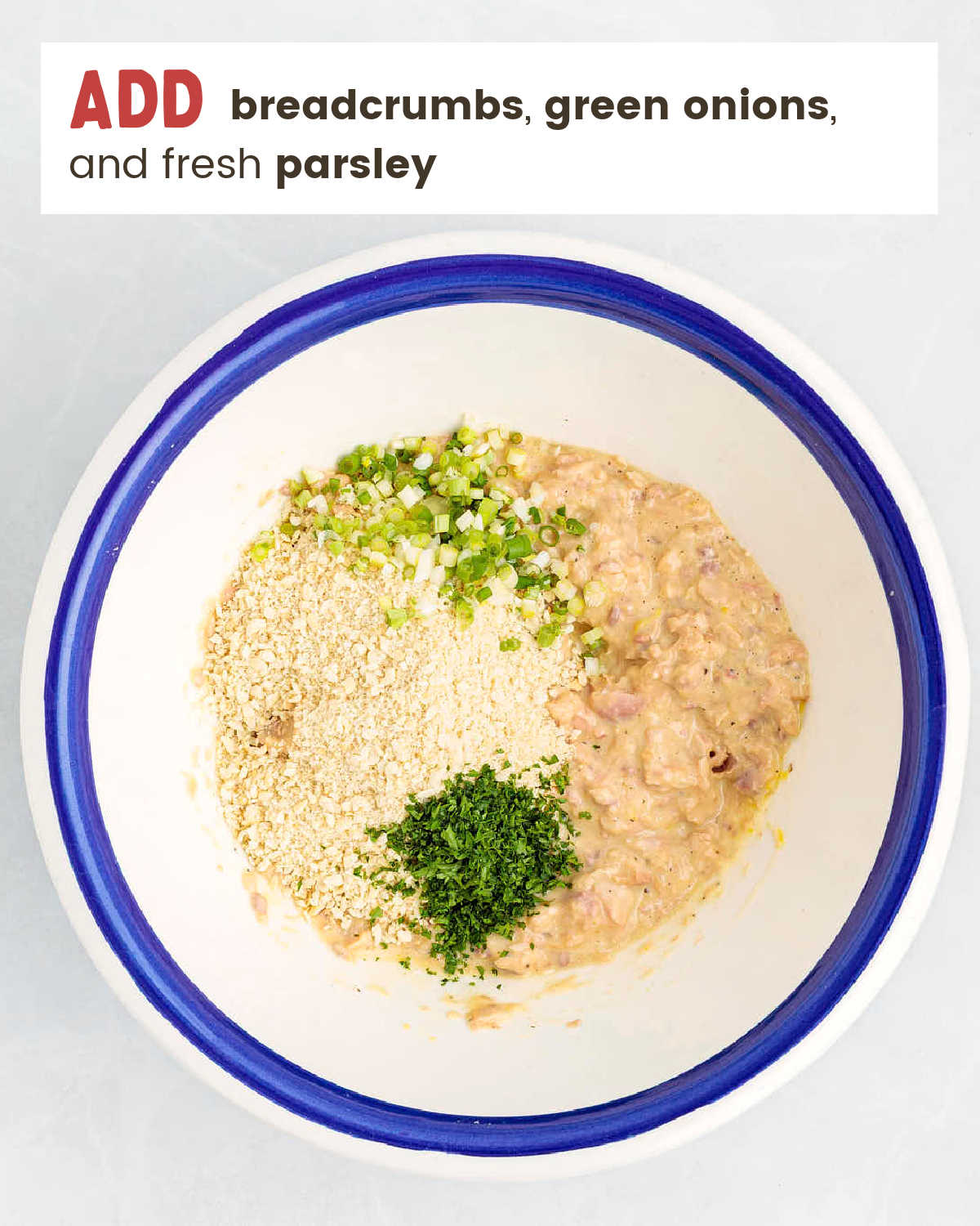 Salmon mixture topped with panko breadcrumbs, green onions, and fresh parsley before mixing.