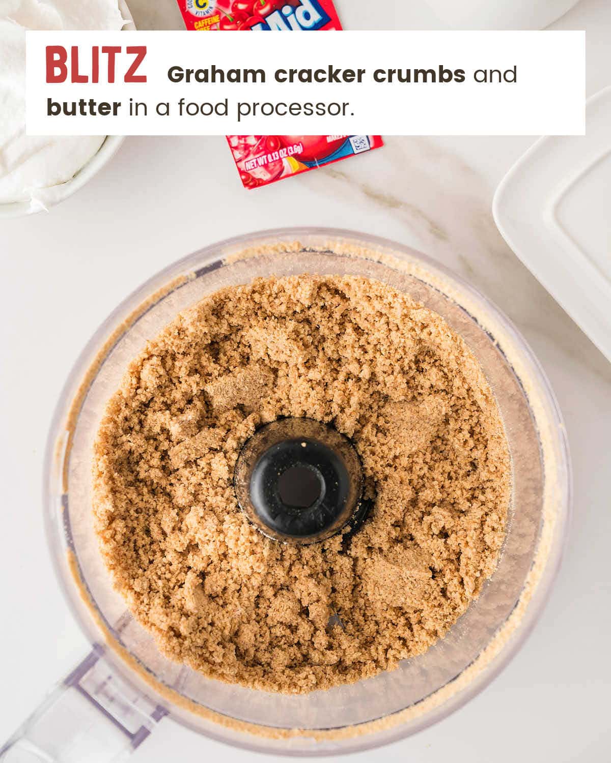 Graham cracker crumb and butter mixture pulsed together in a food processor until clumpy.