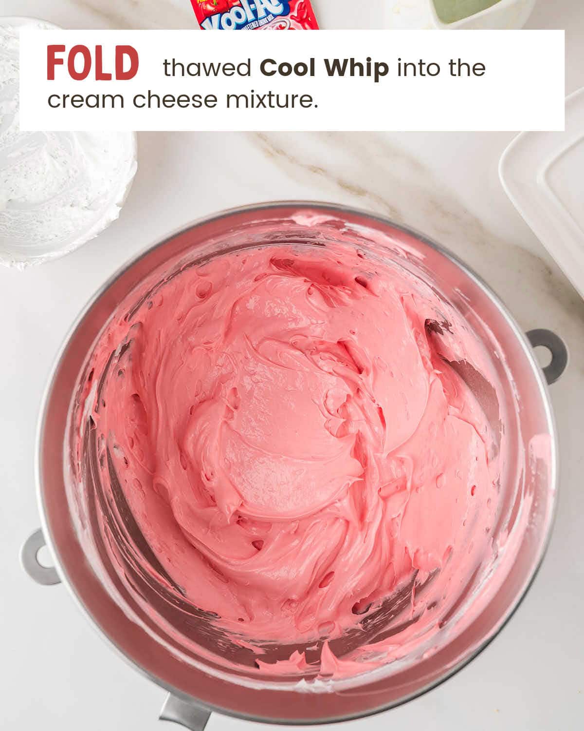 Pink kool aid pie filling spread into a graham cracker crust before chilling.
