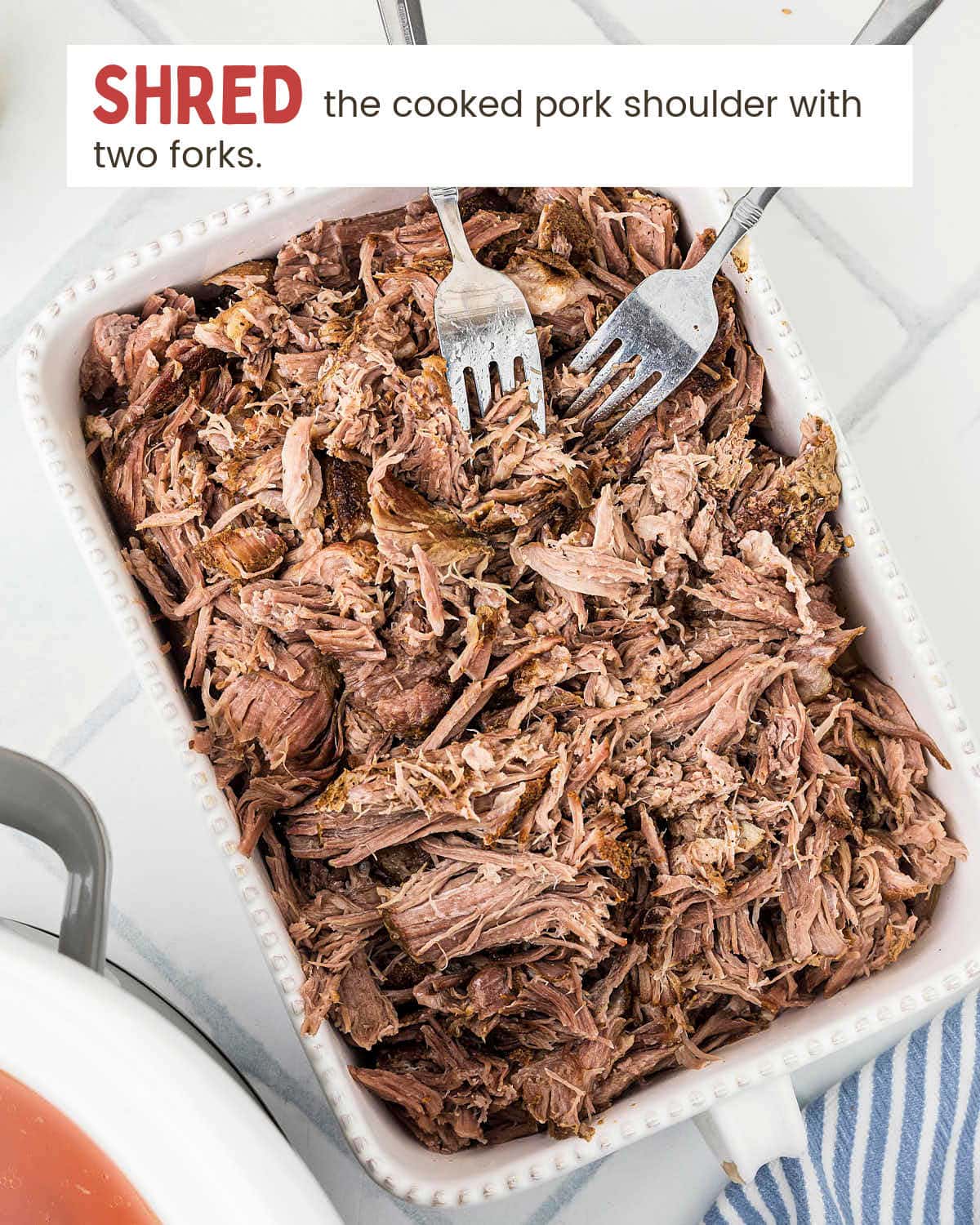 Fork-tender pork shoulder shredded with two forks for slow cooker carnitas.