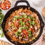 Claude responded: Steak and Rice in a cast iron skillet with white queso and pico de gallo on top, served with extra queso and pico on the side.Steak and Rice in a cast iron skillet with white queso and pico de gallo on top, served with extra queso and pico on the side.