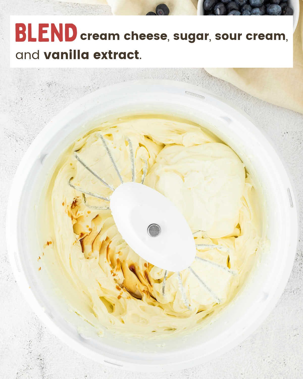 Cream cheese filling beaten smooth in a stand mixer bowl.