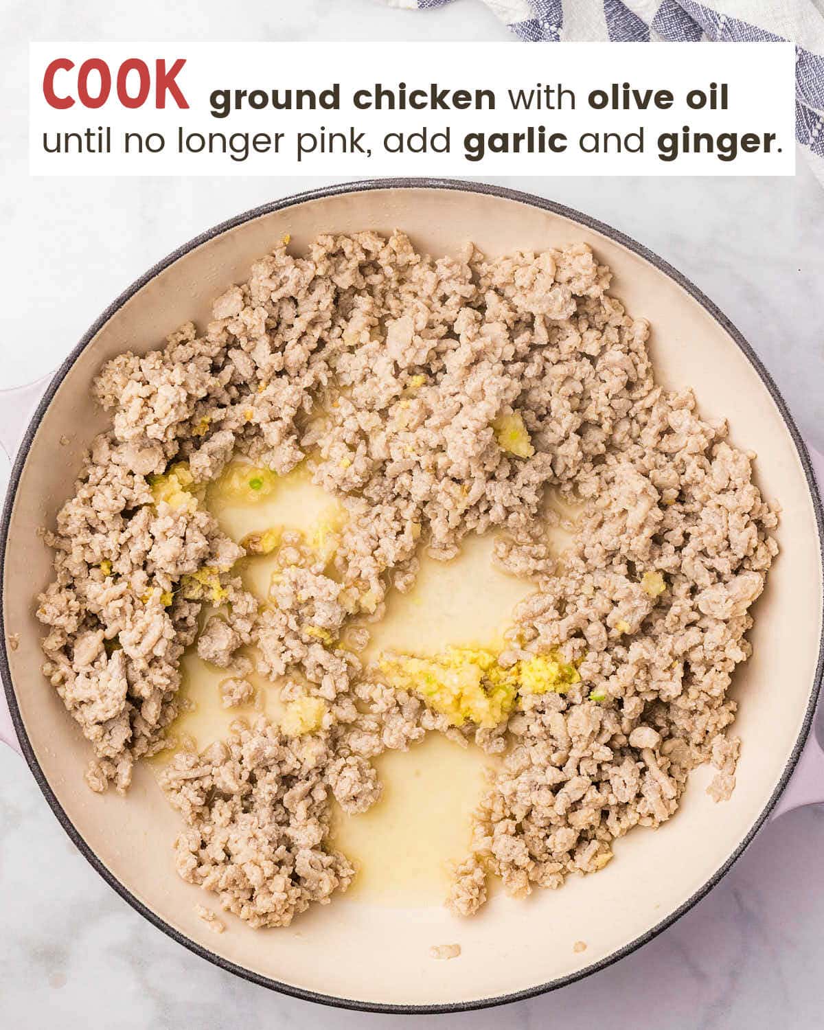 Ground chicken browning in a skillet with grated fresh ginger.