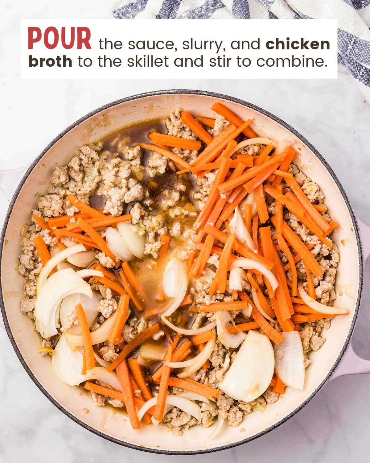 Sauce and chicken broth poured into the skillet with the chicken and vegetables.