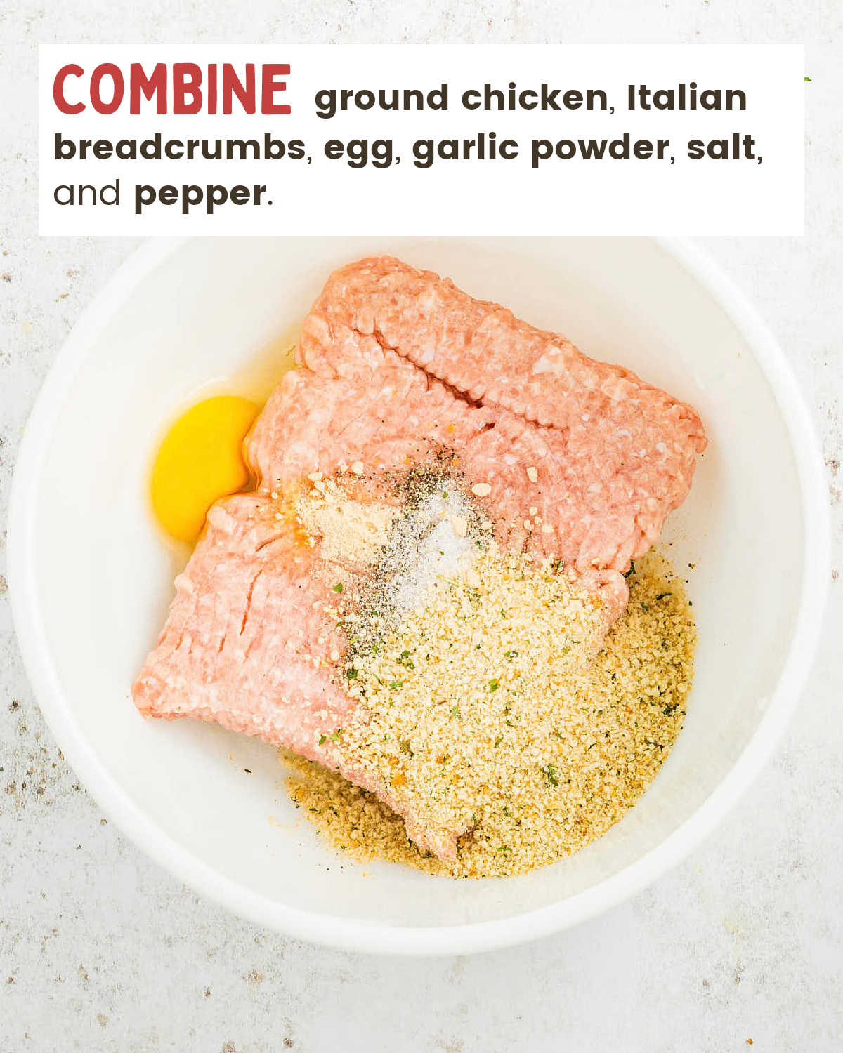 Ground chicken, egg, seasoned breadcrumbs, and spices in a white mixing bowl.