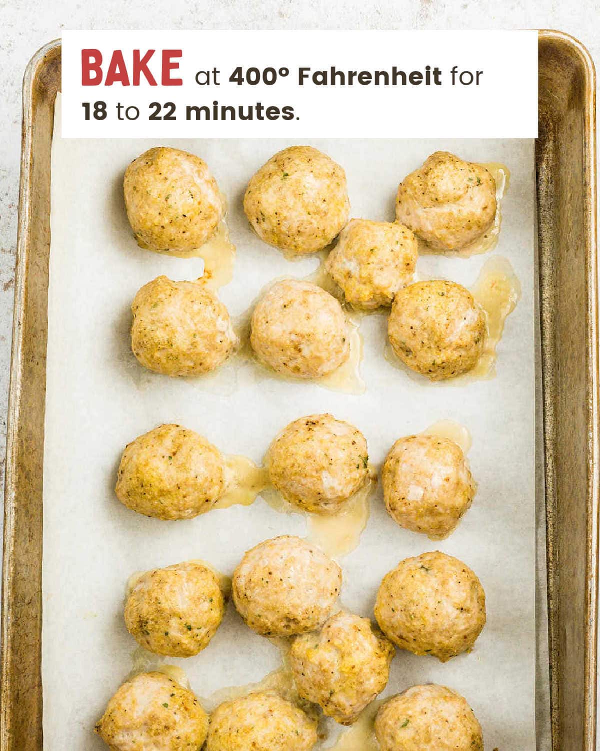 Baked Buffalo Chicken Meatballs on a baking sheet before saucing.
