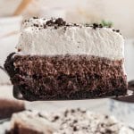 Close-up of a Mississippi Mud Pie slice showing the crust, brownie, mousse, and whipped cream layers.
