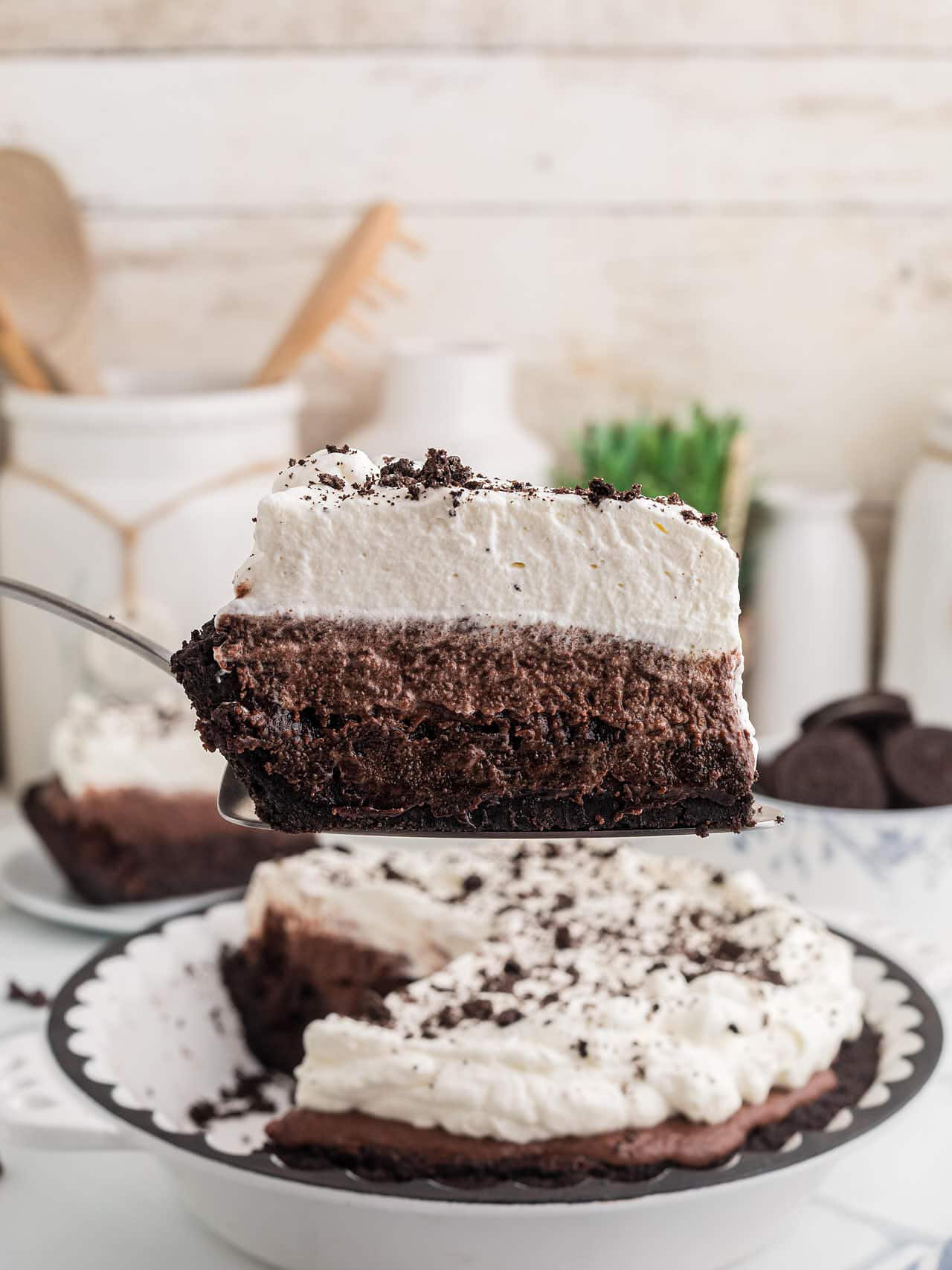 A slice of Mississippi Mud Pie lifted from the pie on a server, showing the layers.