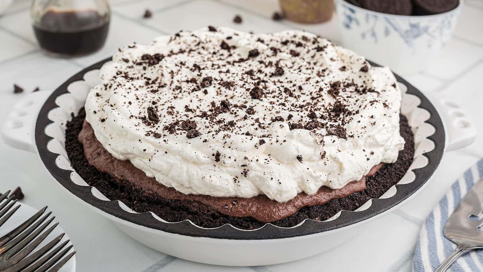 Close overhead view of whipped cream and cookie crumbs on a Mississippi Mud Pie.