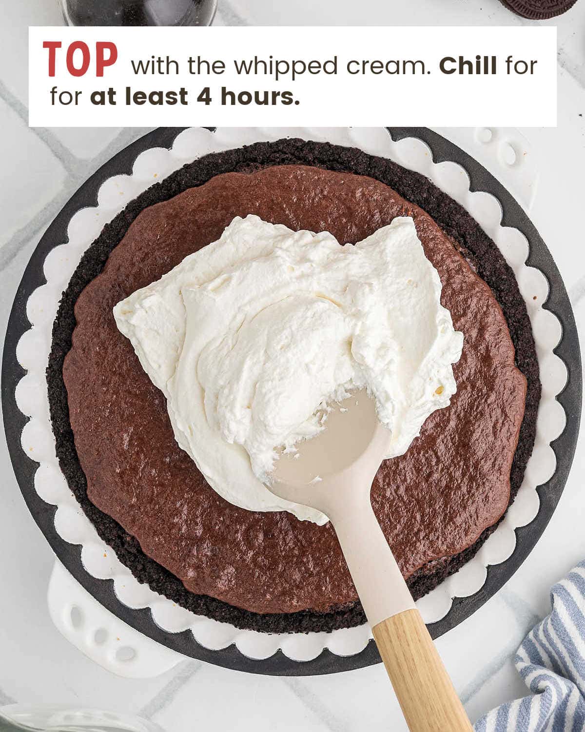 Whipped cream topping spread over the mousse layer of the Mississippi Mud Pie.