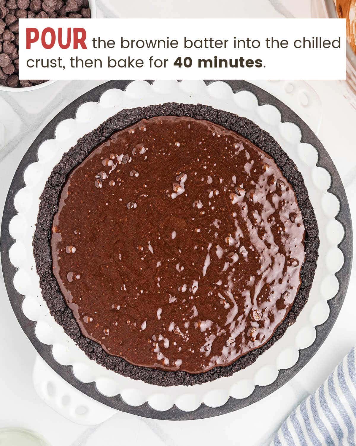 Brownie batter spread over the cookie crust before baking.
