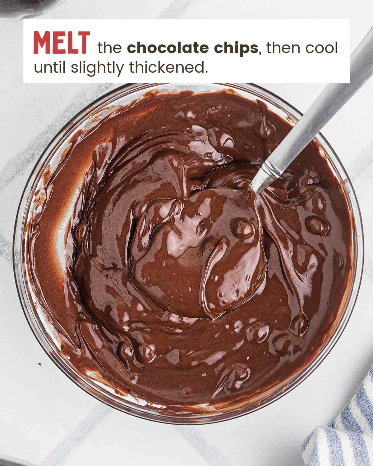 Melted semisweet chocolate stirred smooth in a glass bowl.