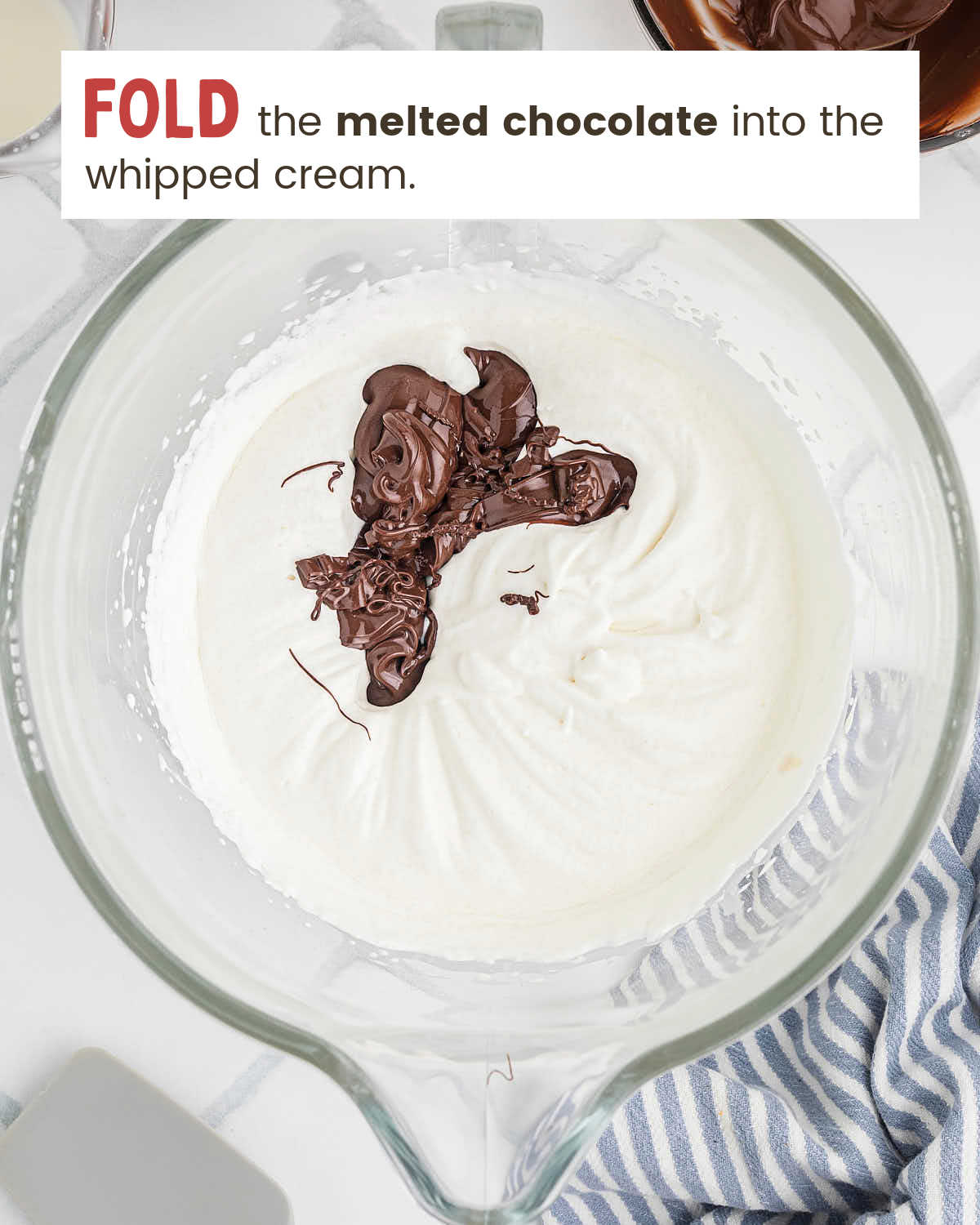 Melted chocolate poured over whipped cream before folding into mousse.