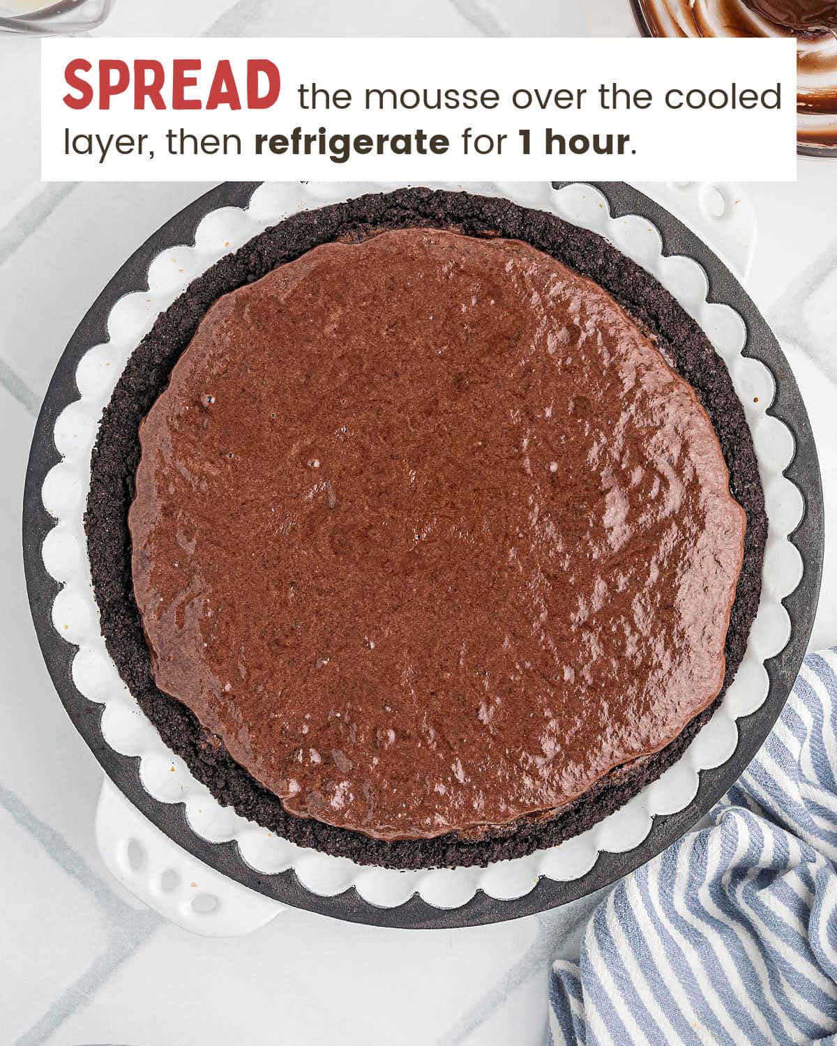 Chocolate mousse spread over the baked brownie layer in the pie.