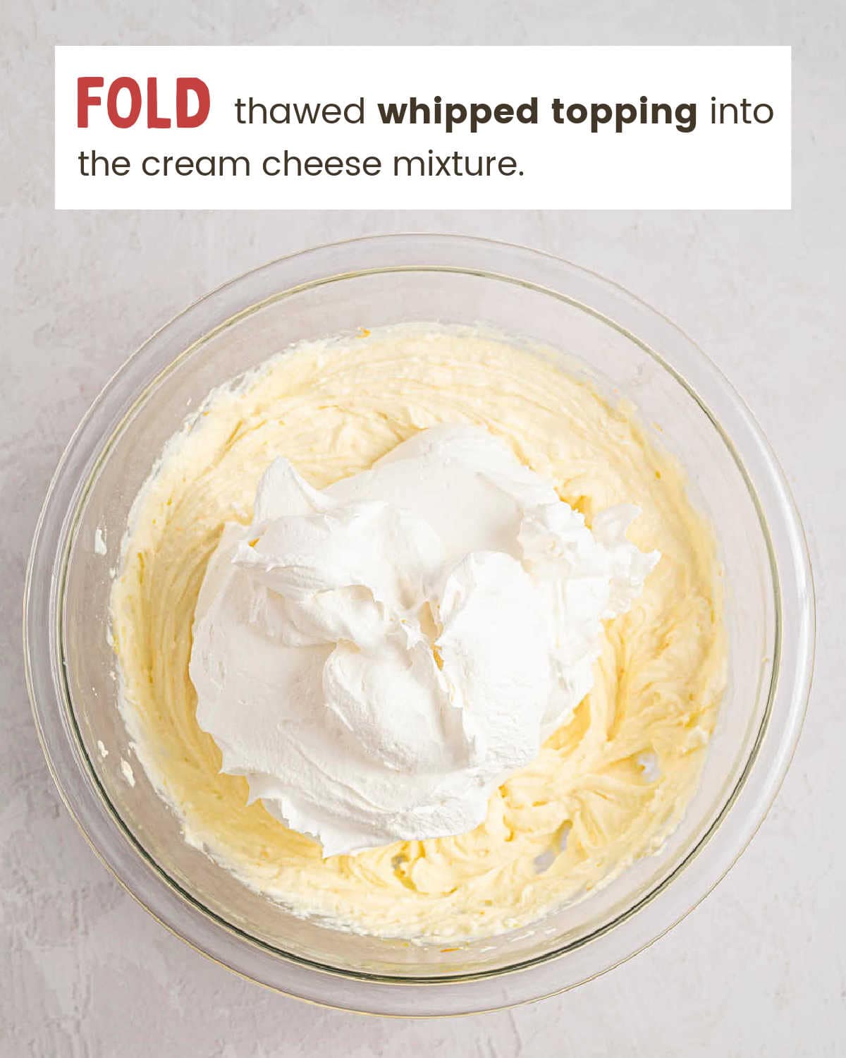 Whipped topping added to the beaten cream cheese and ricotta mixture.