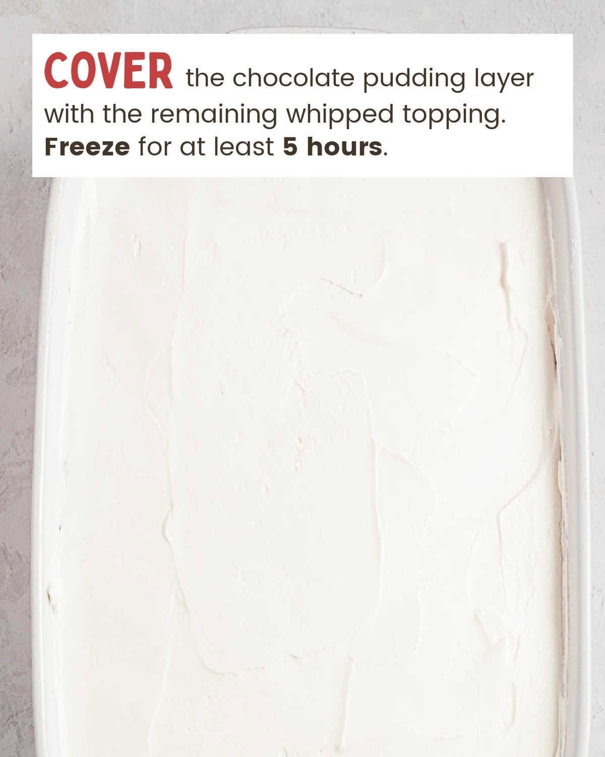 Whipped topping spread in an even layer over the chocolate pudding.