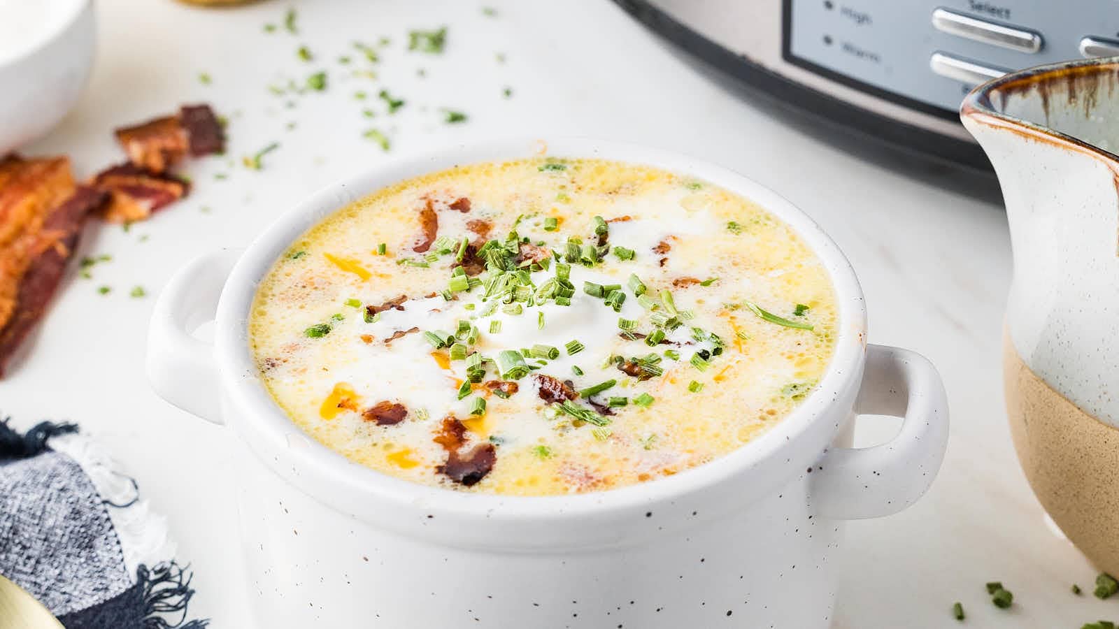 Creamy Crockpot Loaded Potato Soup in a white soup bowl.