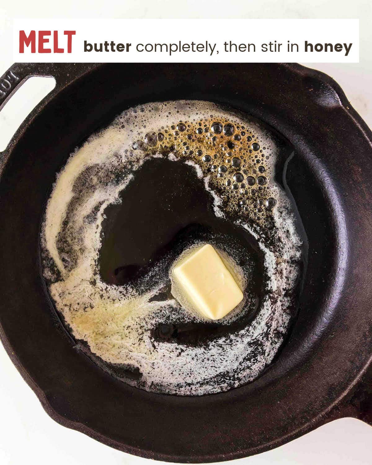 Butter melting in a cast iron skillet for Honey Butter Skillet Corn.