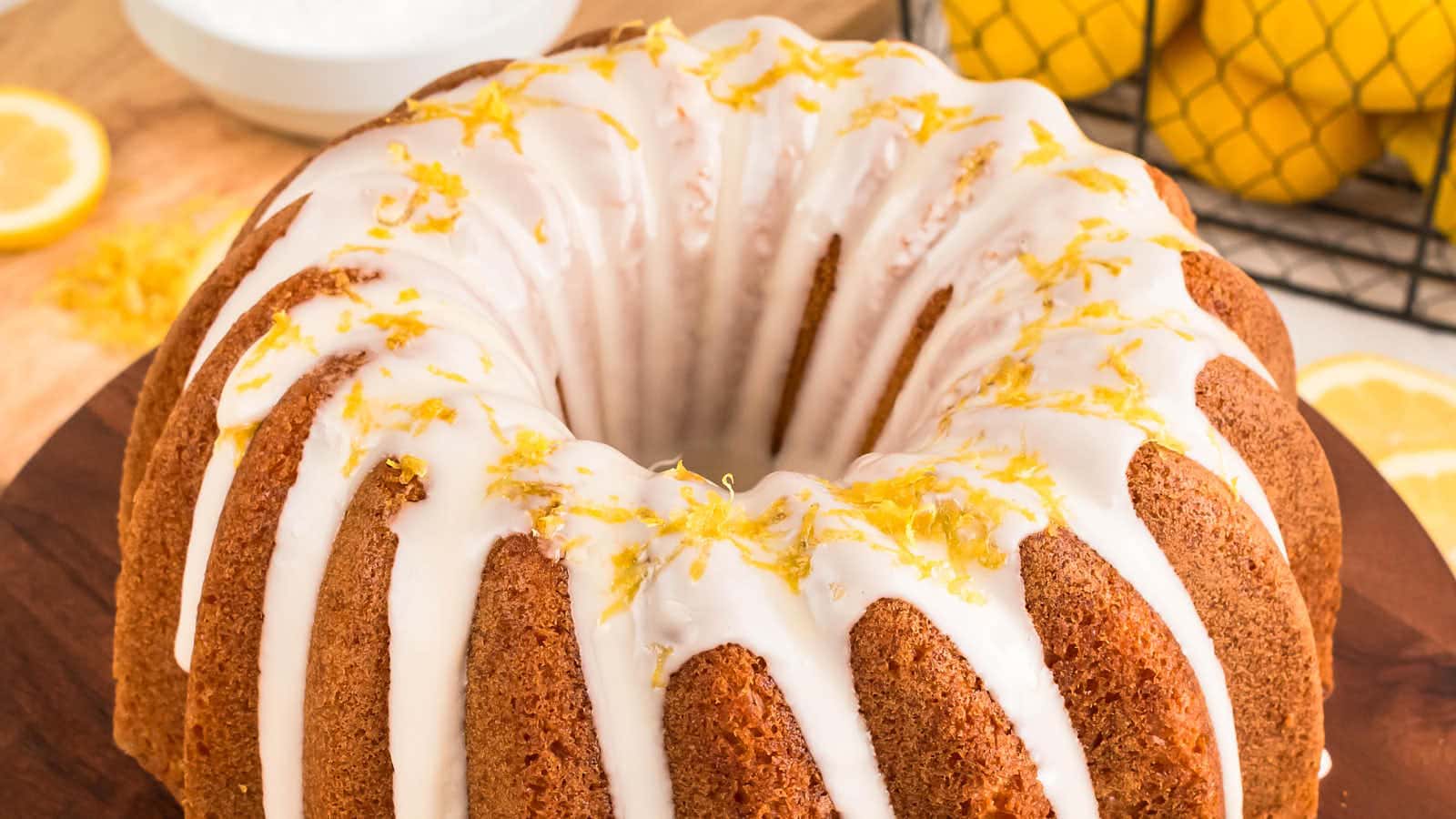 Lemon zest scattered over the glazed top of a Lemon Bundt Cake.