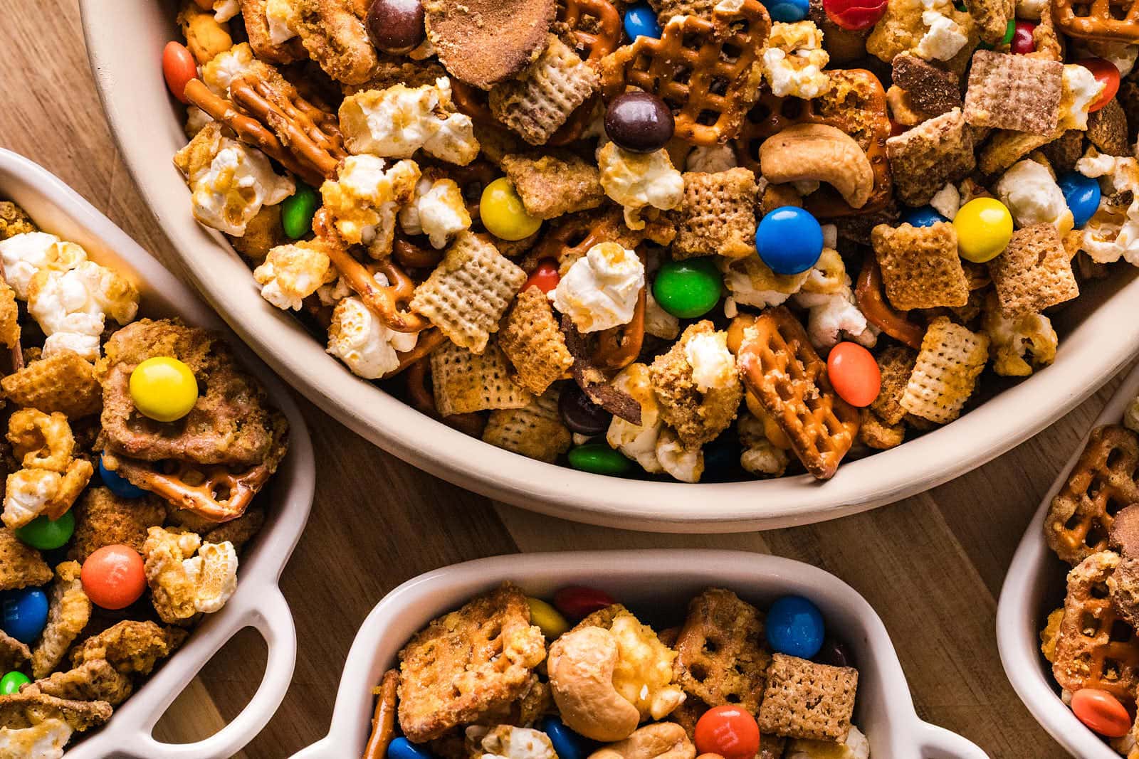 Overhead bowl of Sweet and Salty Chex Mix with pretzels, popcorn, cashews, and M&Ms.