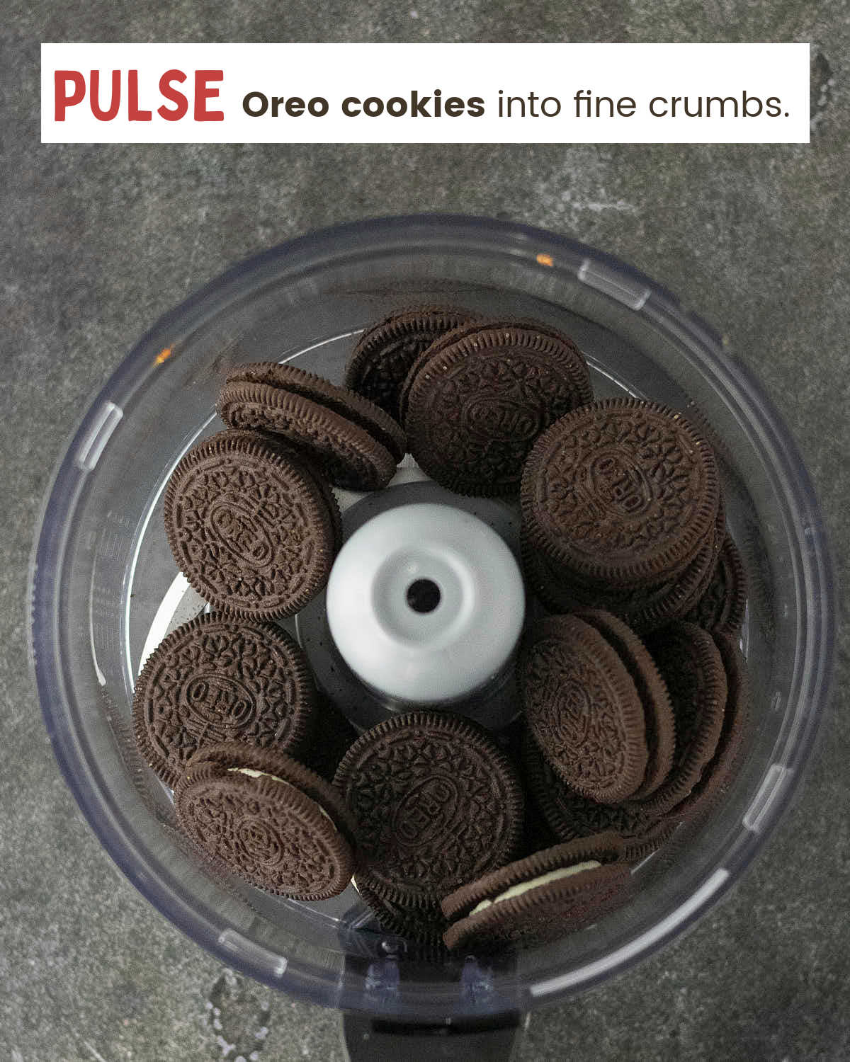 Whole Oreo cookies in a food processor before pulsing into crumbs.