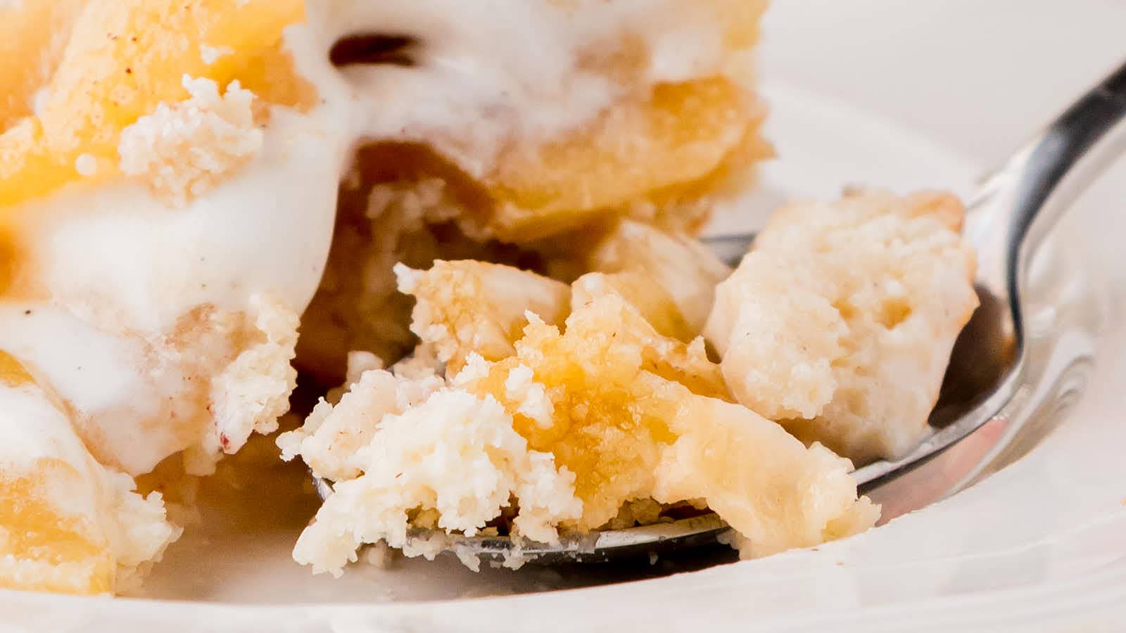 Closeup of a bite of Apple Cobbler on a spoon.