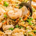 Chicken and Shrimp Fried Rice piled high on a serving spoon over the skillet.
