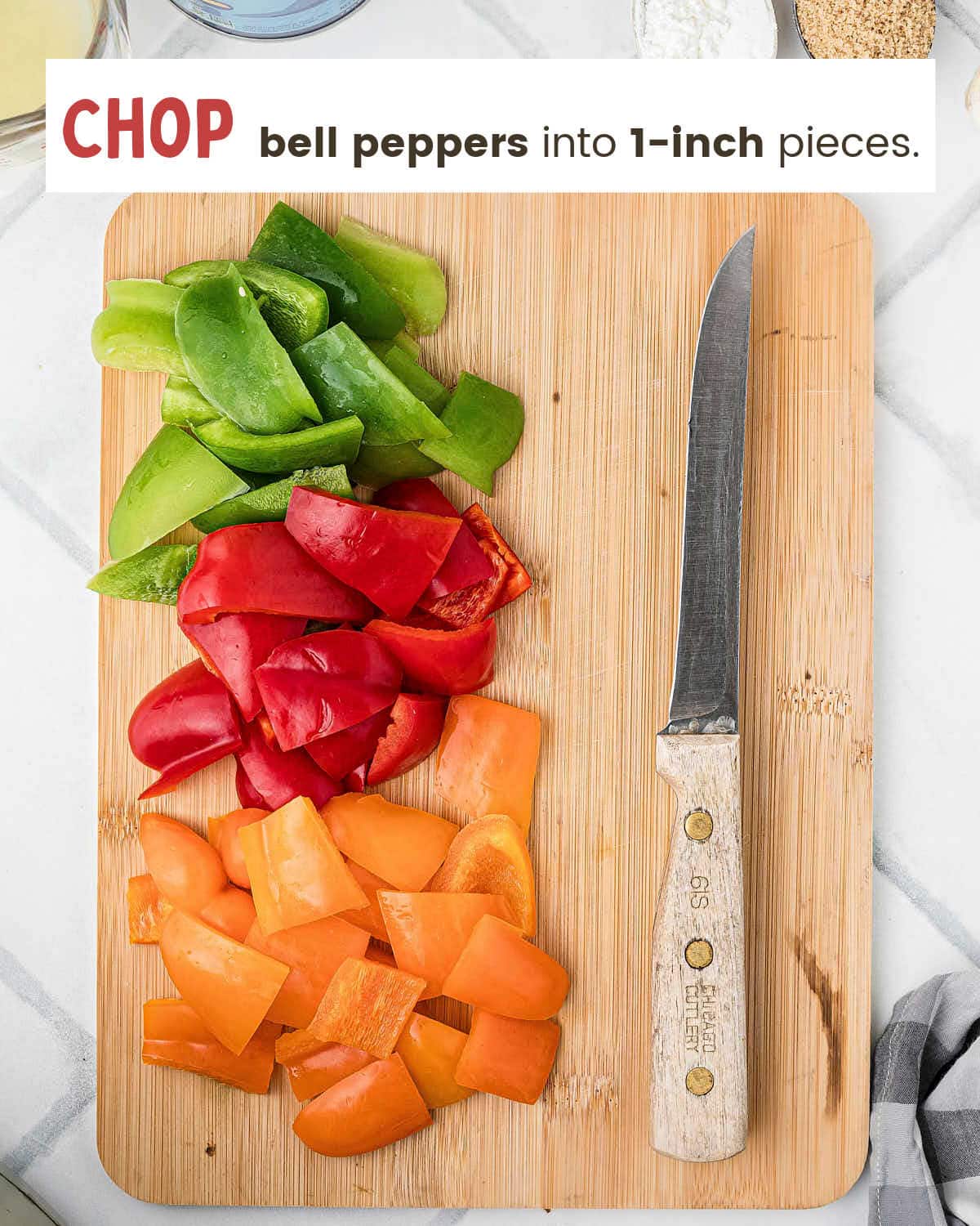 Chopped green, red, and orange bell peppers on a wooden cutting board.