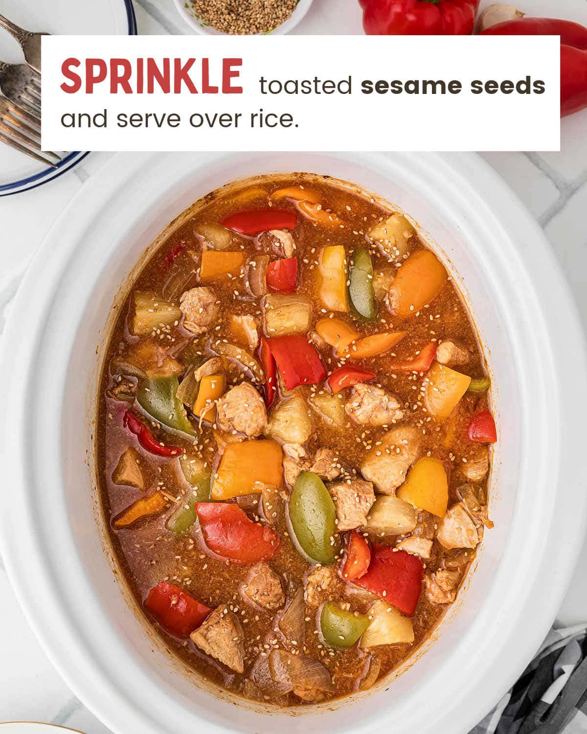 Finished Crockpot Sweet and Sour Chicken topped with toasted sesame seeds in the slow cooker.