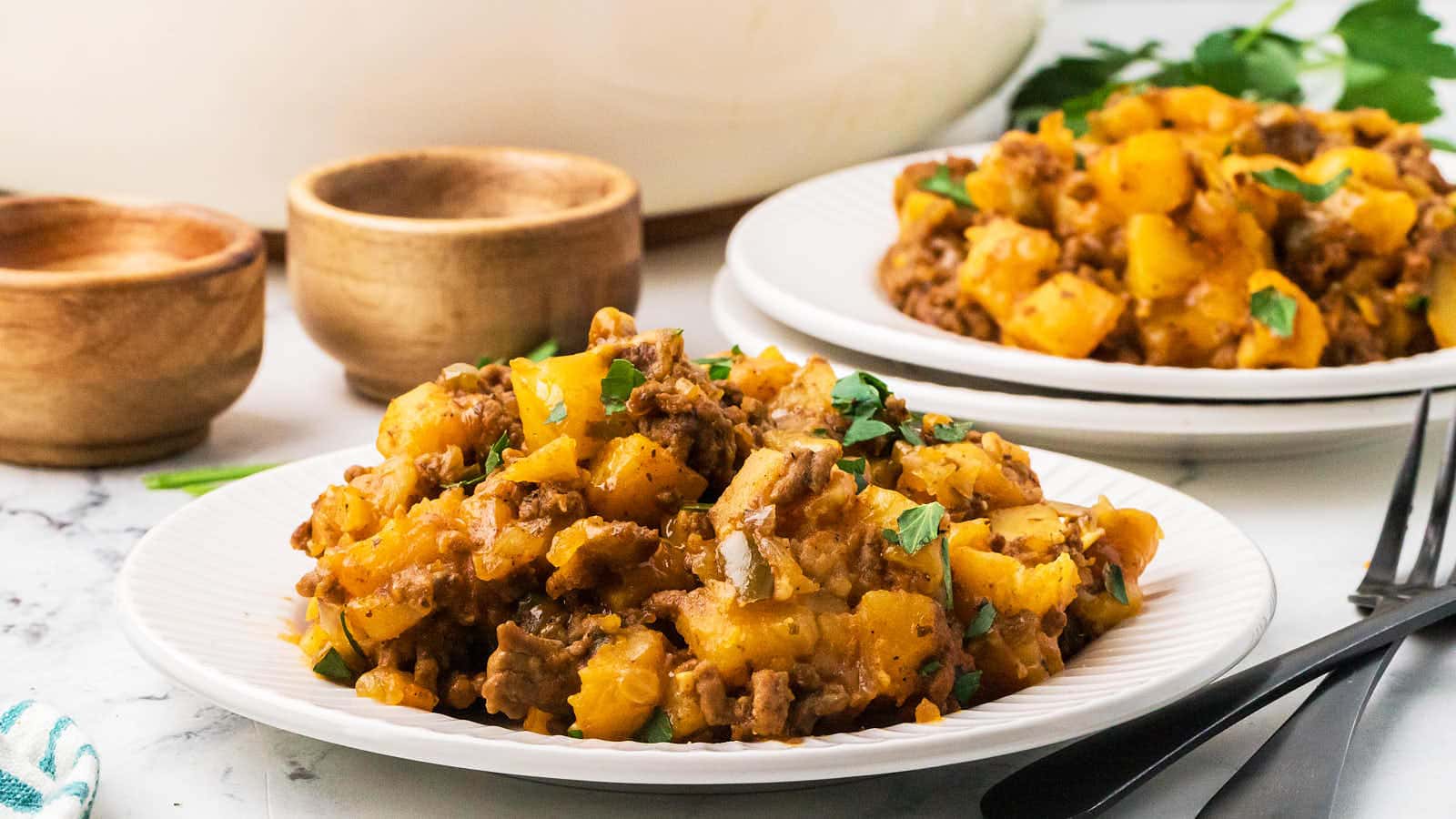 Serving of Ground Beef and Potatoes on a white plate.