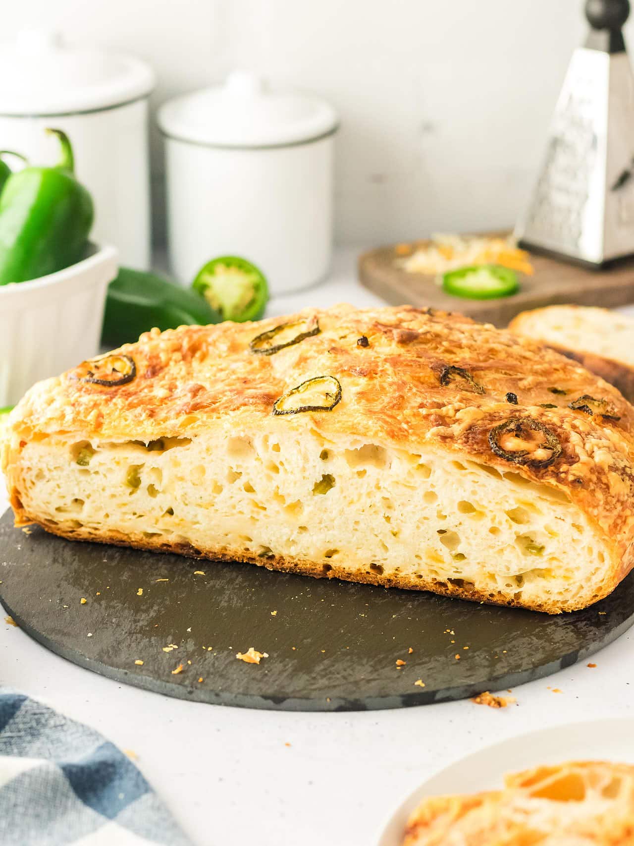 Jalapeño Cheddar Bread with a golden cheese crust, cut open to show the soft crumb.
