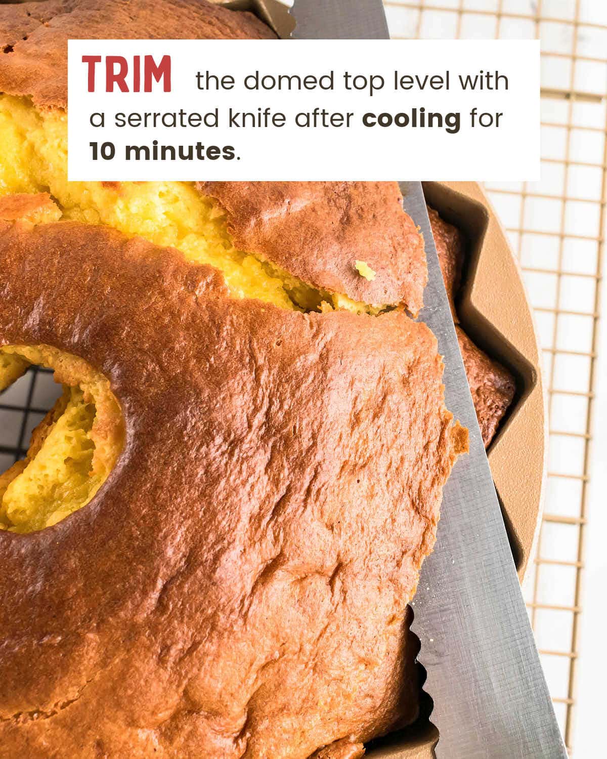 Serrated knife cutting the baked dome even with the pan edge.