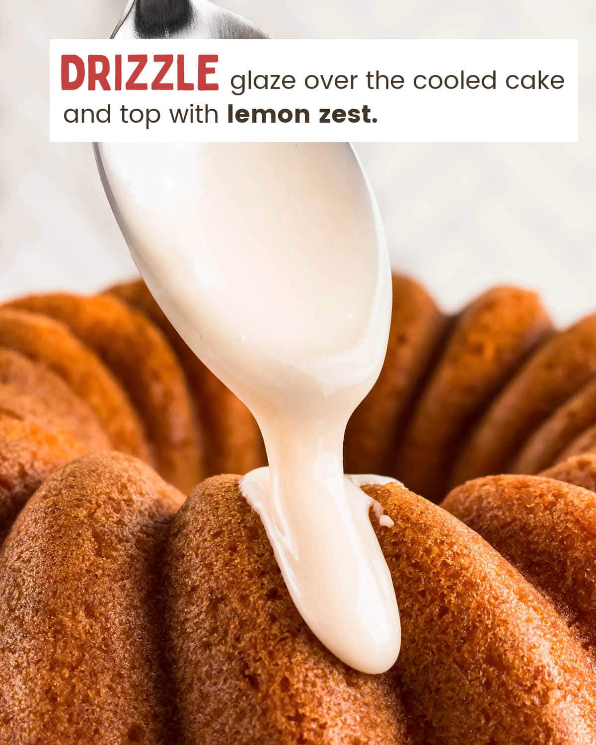Vanilla glaze pouring from a spoon onto the fluted cake.
