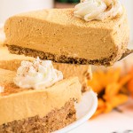 A slice of No Bake Pumpkin Cheesecake on a cake server with the whole dessert below.