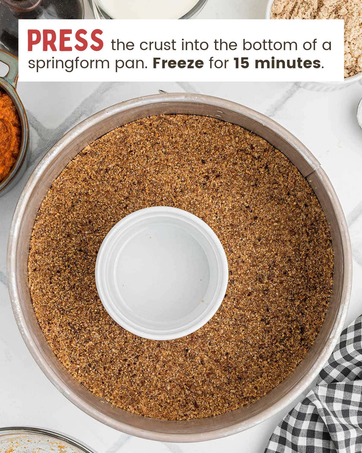 Pecan graham cracker crust pressed evenly into the bottom of a springform pan.