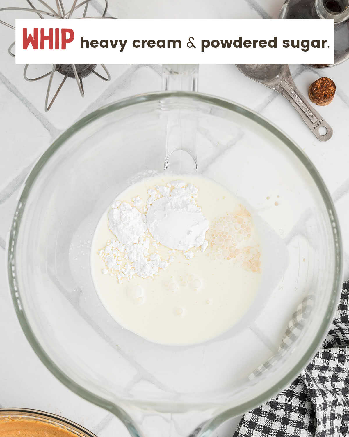 Heavy whipping cream and powdered sugar in a mixing bowl before whipping.