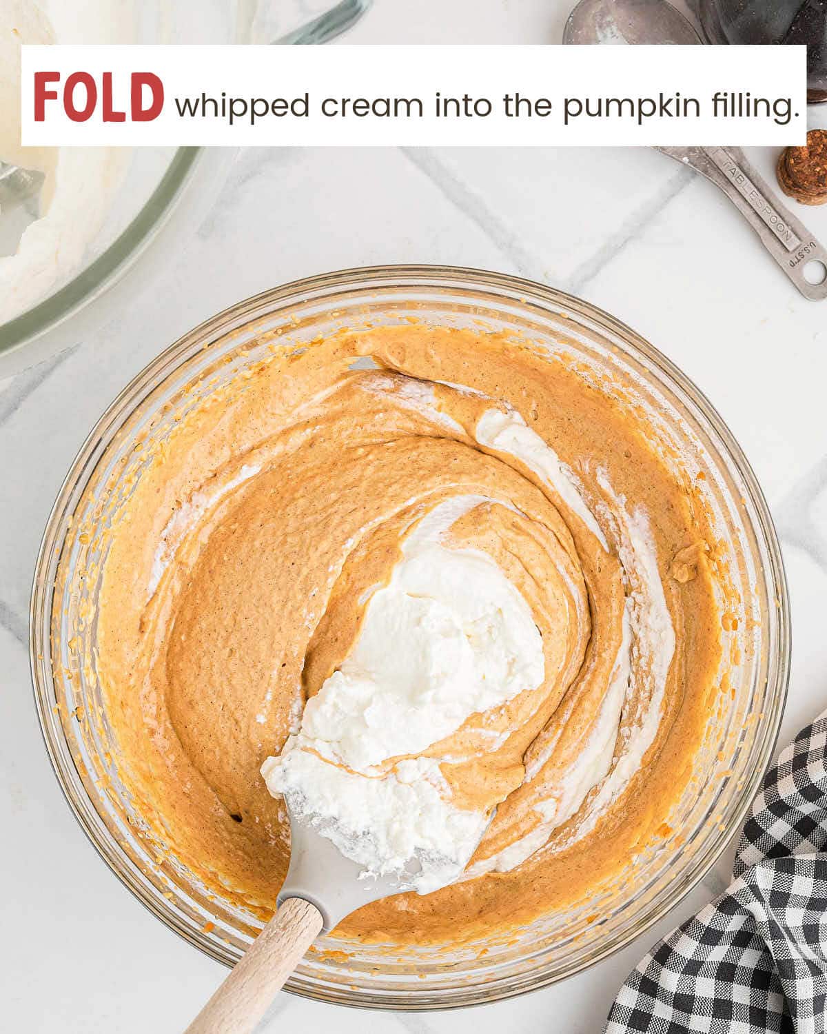 Whipped cream folded into the spiced pumpkin filling with a spatula.