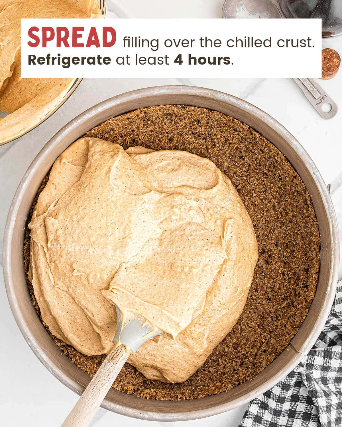 Creamy pumpkin filling spread over the chilled crust in a springform pan.