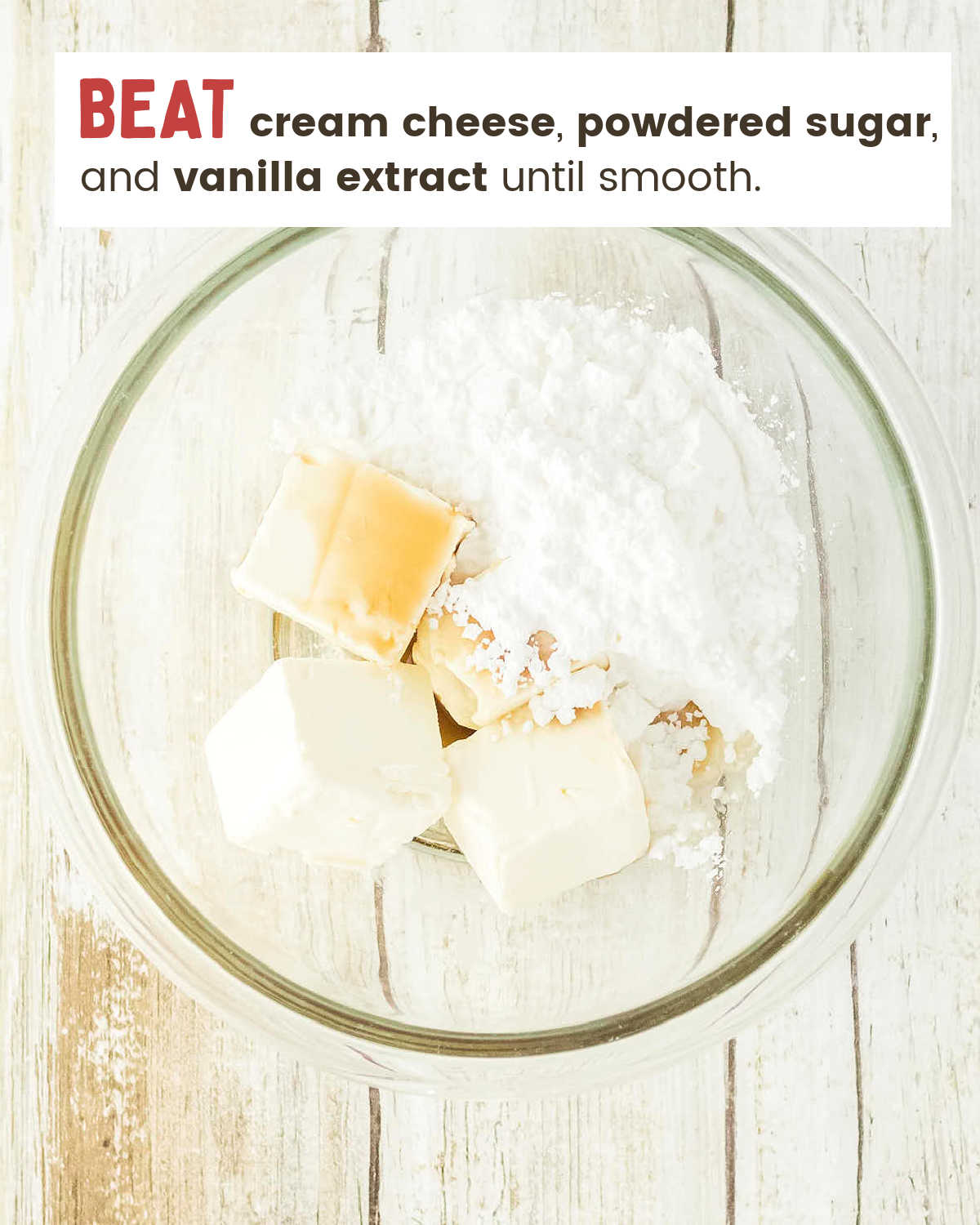 Cream cheese, powdered sugar, and vanilla in a glass bowl for the cheesecake filling.
