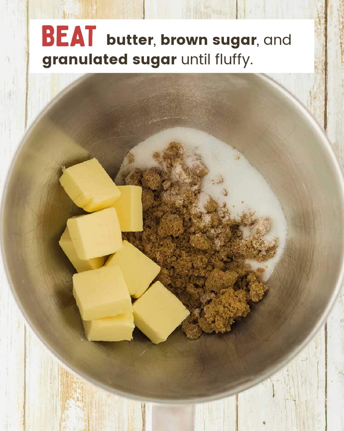 Cubed butter with brown sugar and granulated sugar in a stand mixer bowl.