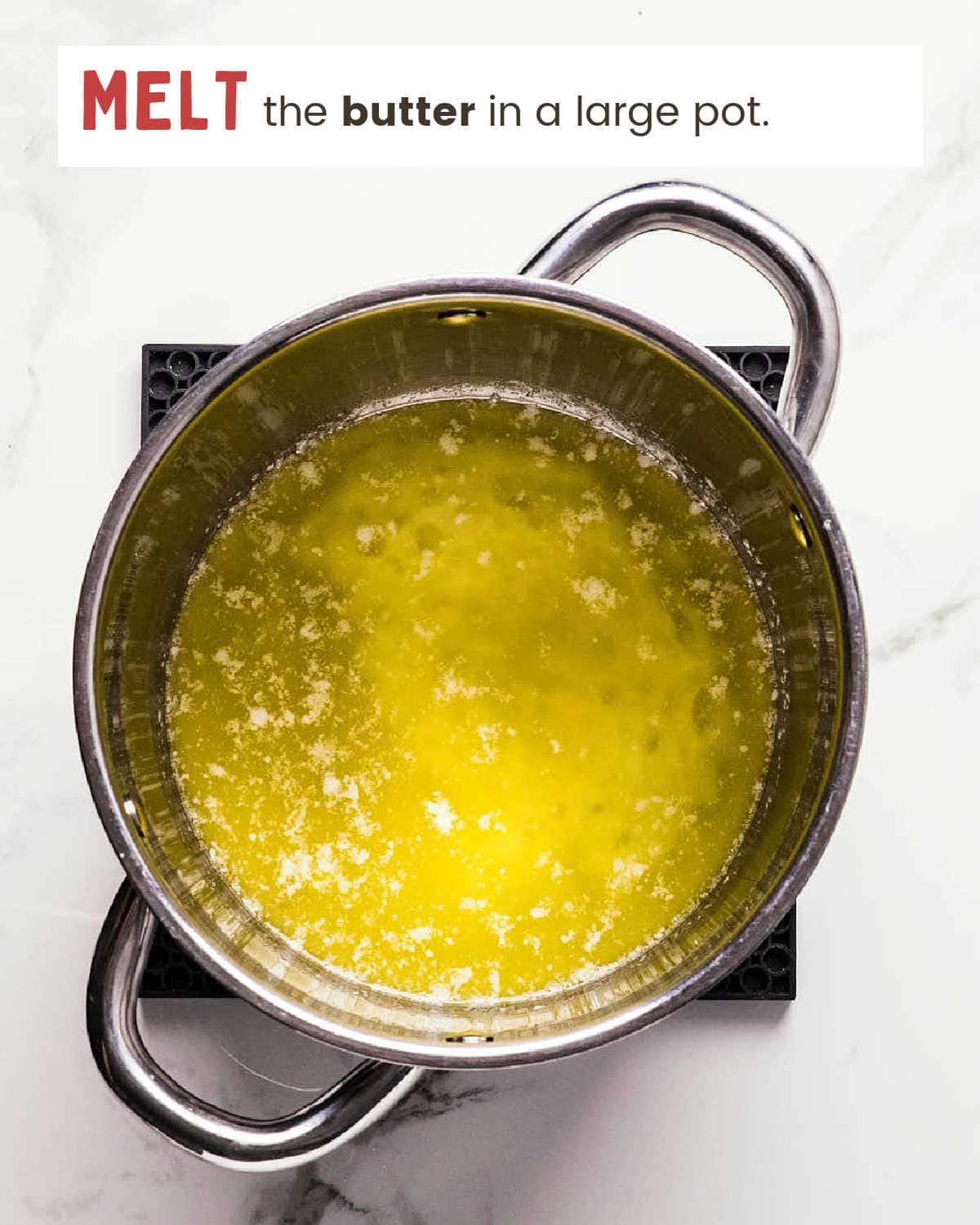 Melted butter in a pot for the Sweet and Salty Chex Mix candy coating.