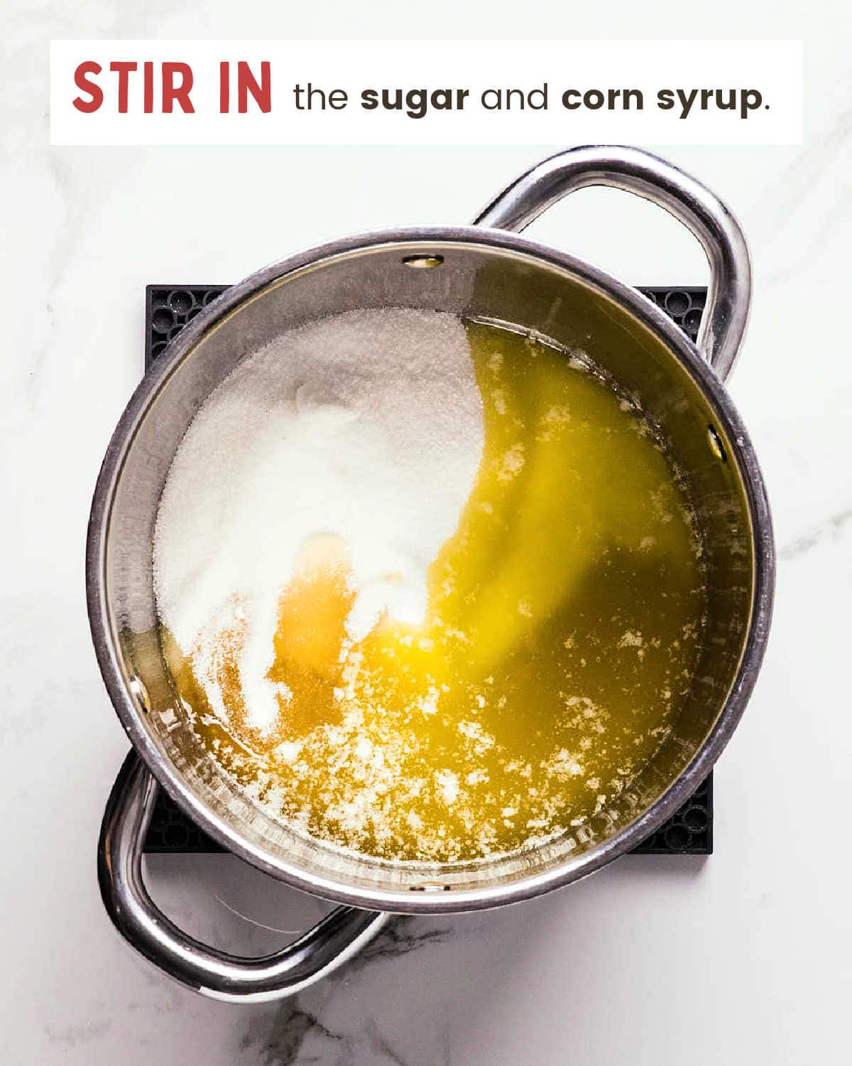 Sugar and corn syrup added to melted butter in a pot.