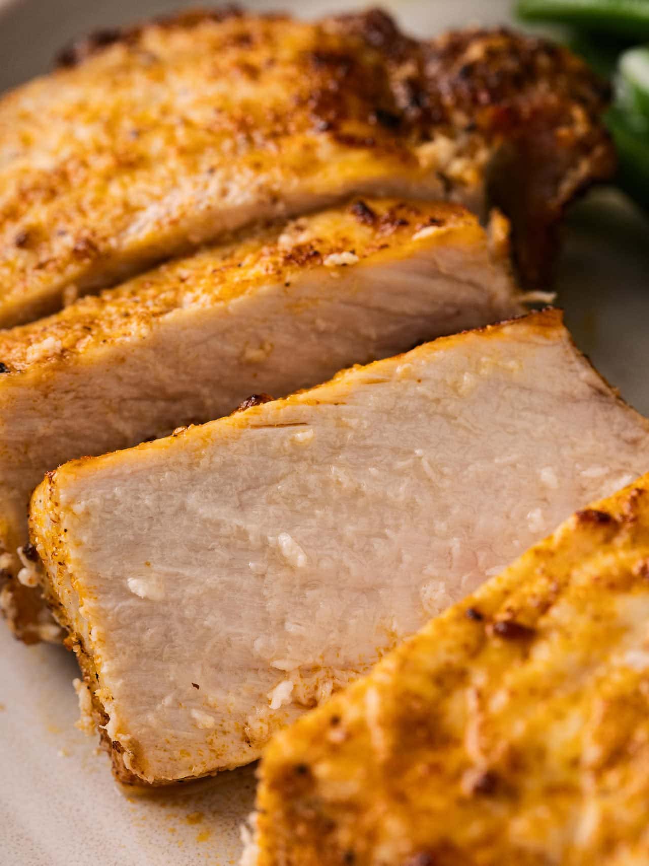 Close-up of sliced Air Fryer Pork Chops showing the juicy interior and seasoned crust.